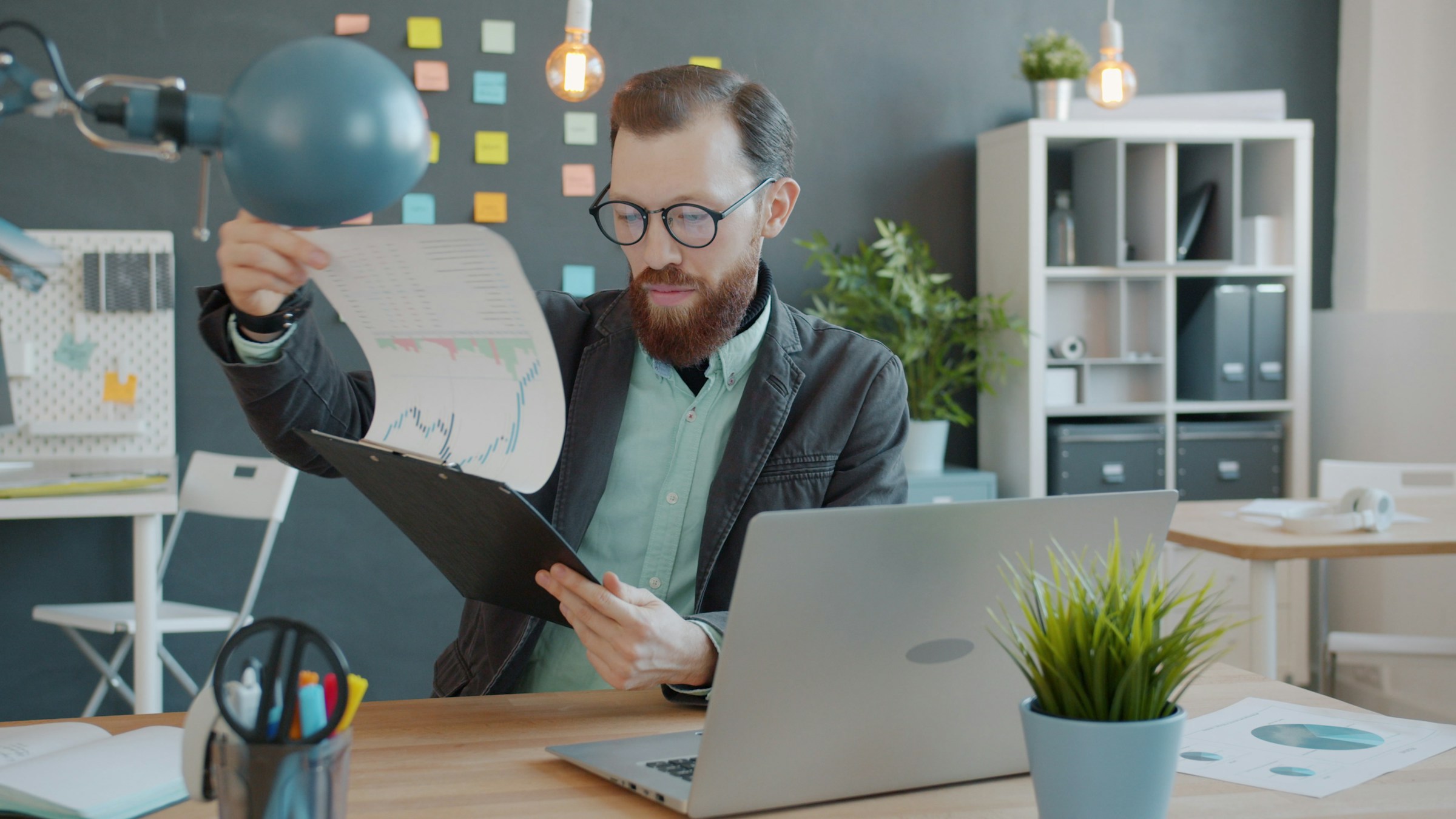 Construction professional reviewing documents at office desk
