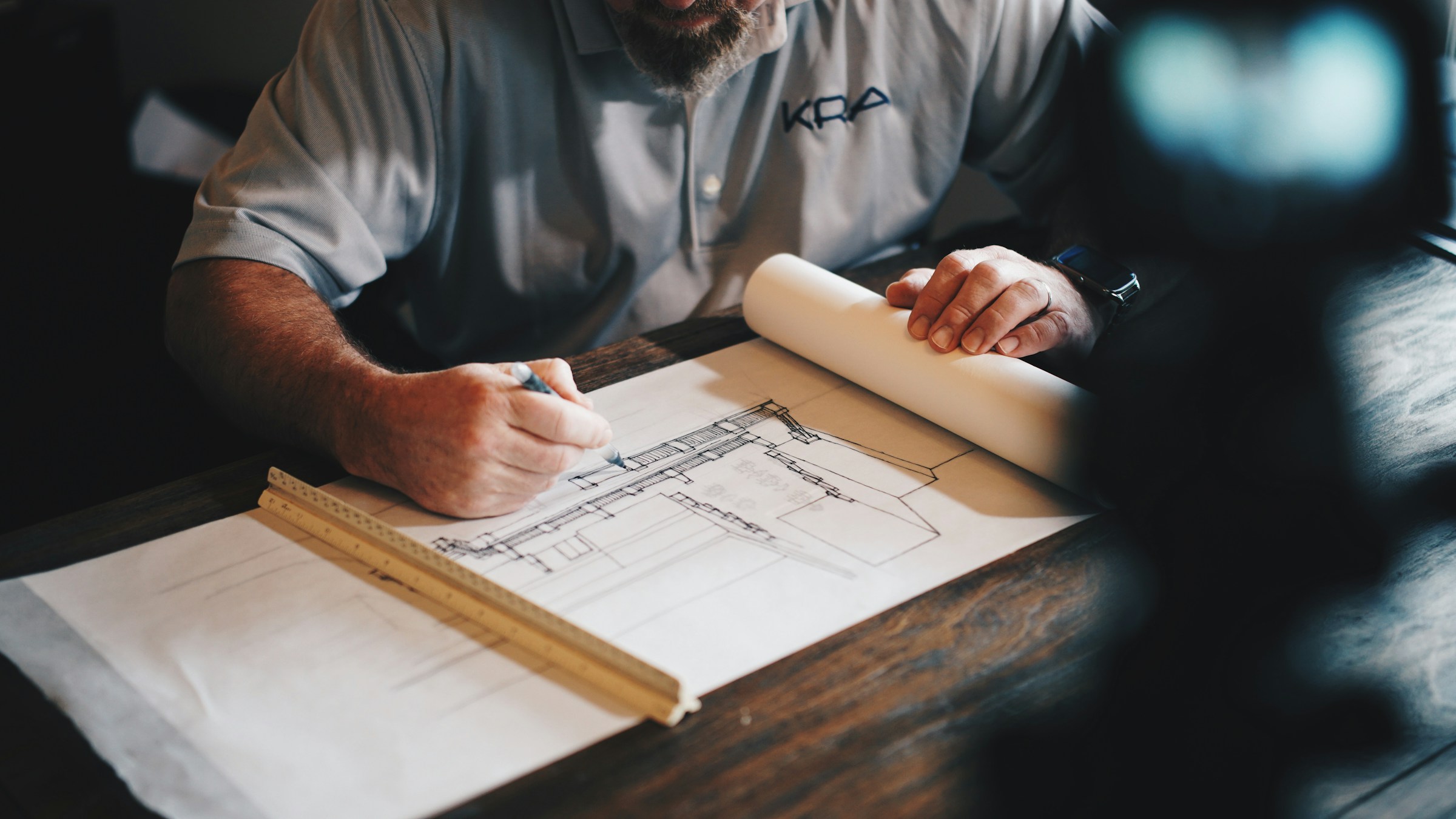 Architect reviewing construction drawings and blueprints